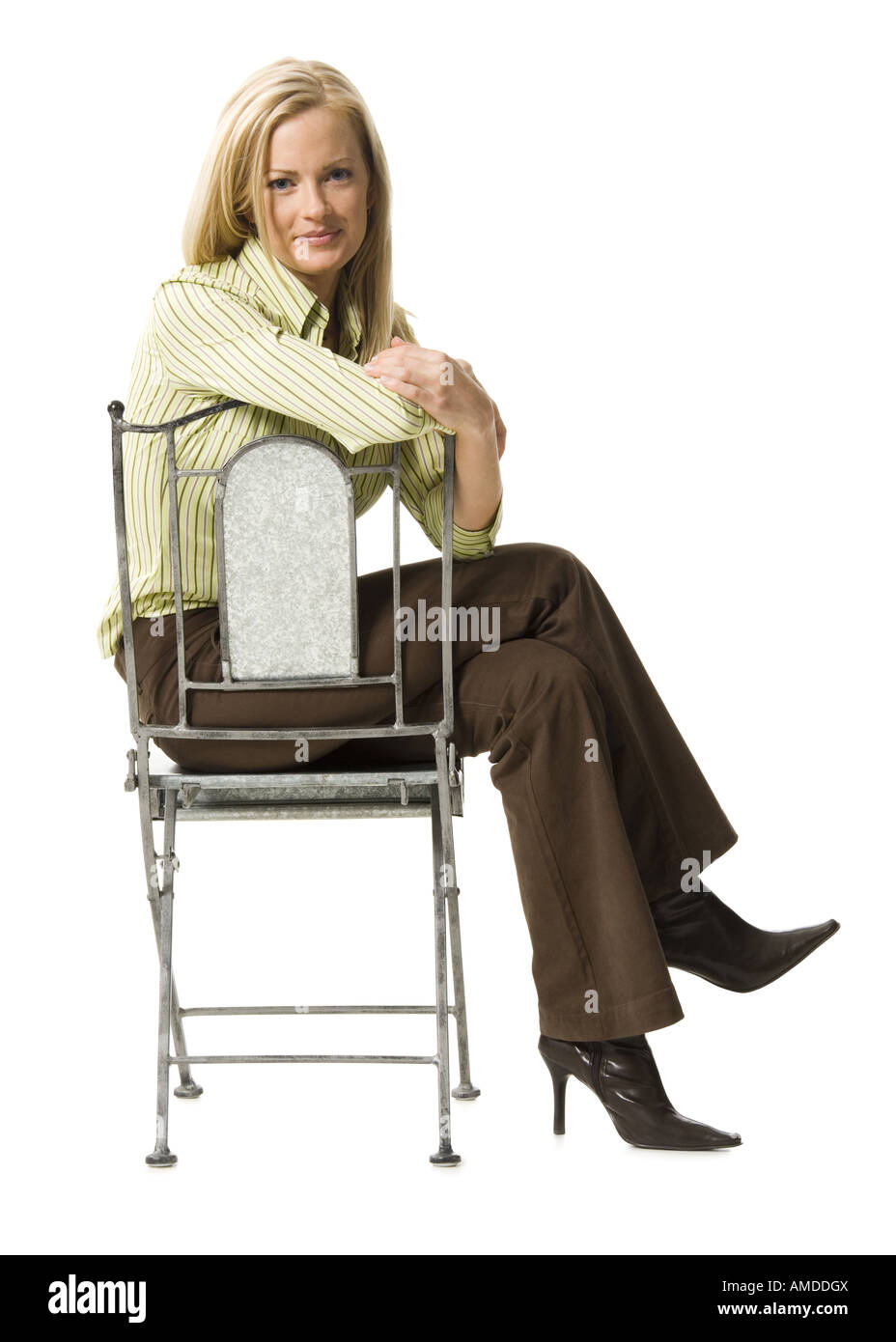 Woman sitting in chair smiling Stock Photo - Alamy