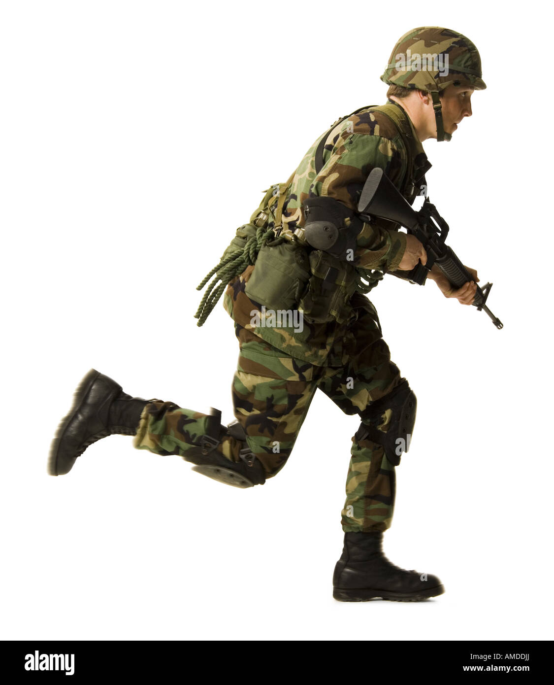 Soldier in uniform with gun running Stock Photo