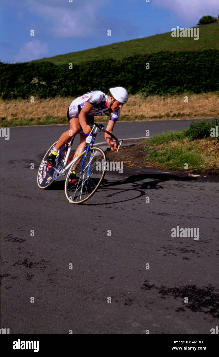 Racing cyclist on a bicycle with carbon fibre disc wheel Milk