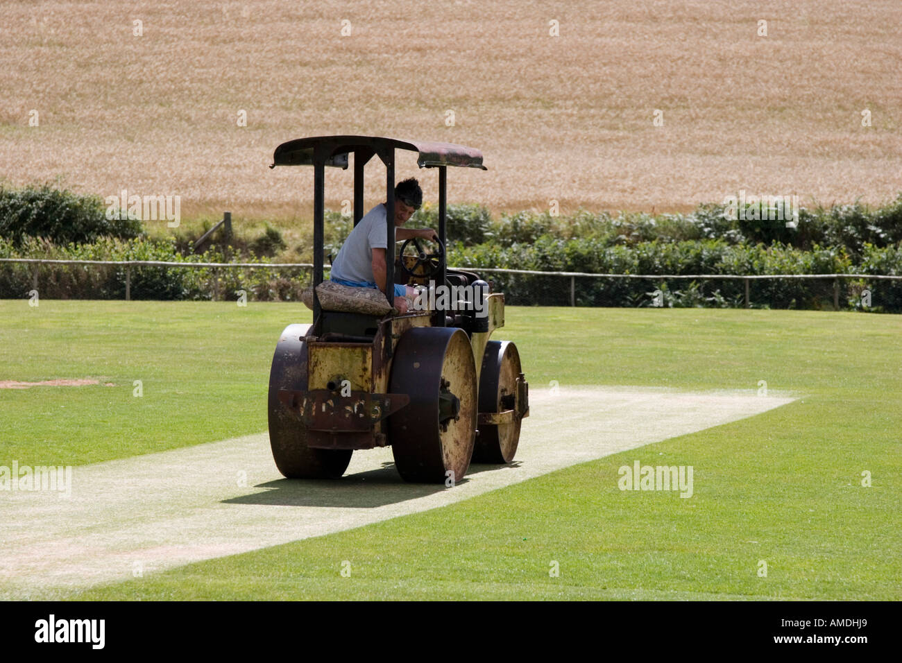 Mechanical roller irons out any bumps on the cricket pitch and wicket Stock Photo