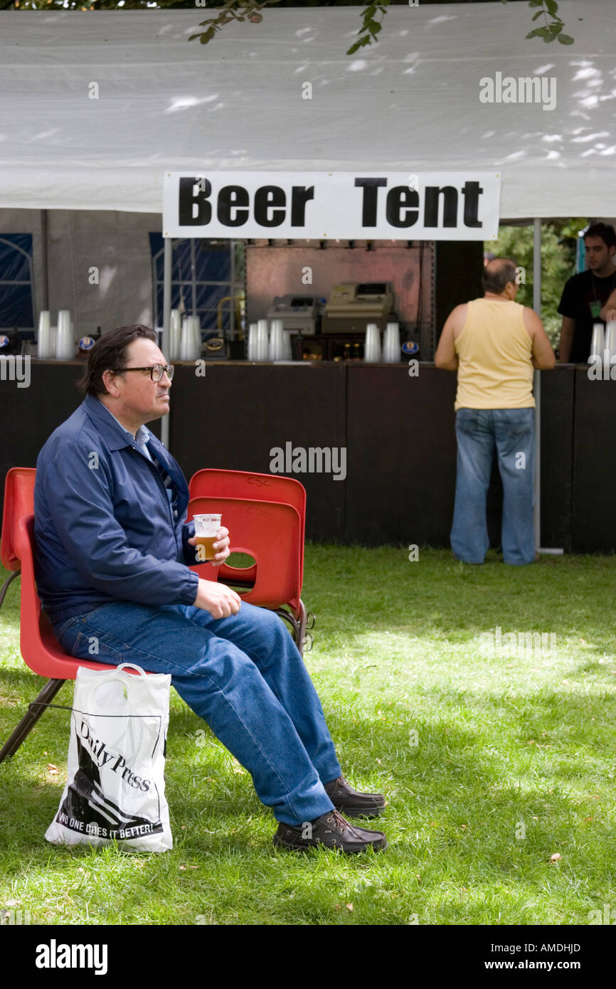 Lone drinker at the beer tent Stock Photo