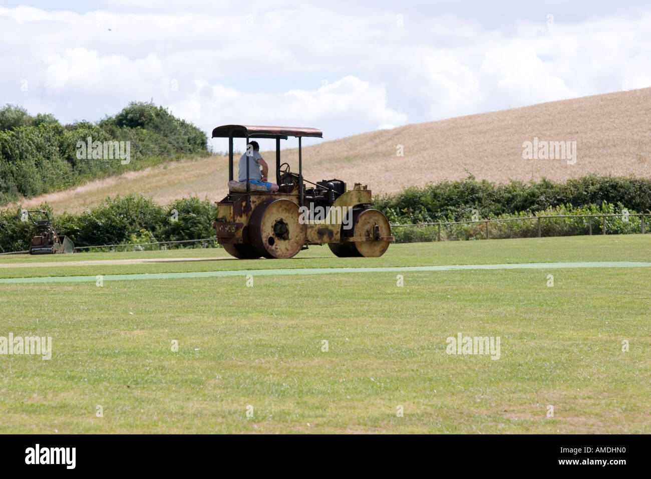 Mechanical roller irons out any bumps on the cricket pitch and wicket Stock Photo