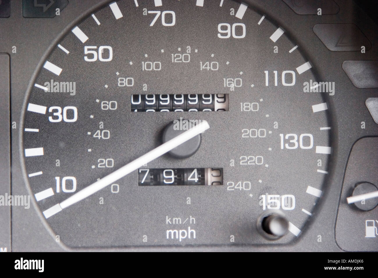 Odometer clock ticking over from 99 999 to 100 000 miles Stock Photo