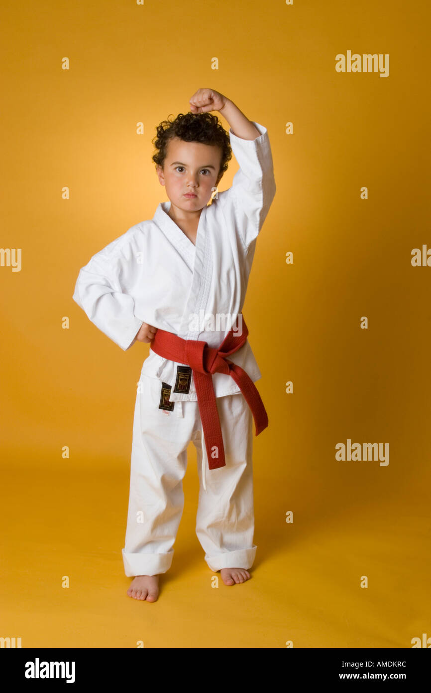 Small boy demonstrating karate stance and kick Stock Photo