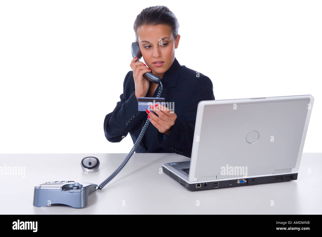 Office worker reading credit card Stock Photo