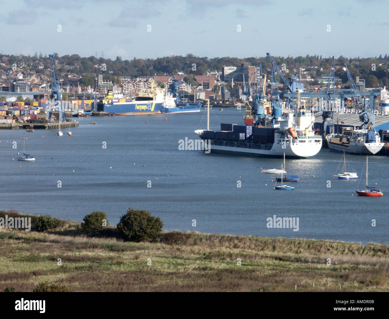 Ipswich county town of Suffolk container ship moving up the river Orwell towards Ipswich docks at high tide Stock Photo