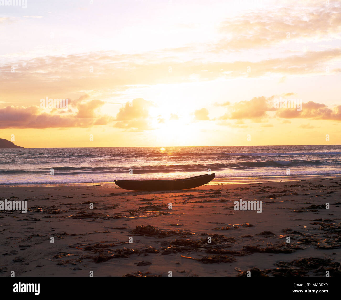old traditional small sea craft sitting on the sandy shore on irelands atlantic coast Stock Photo
