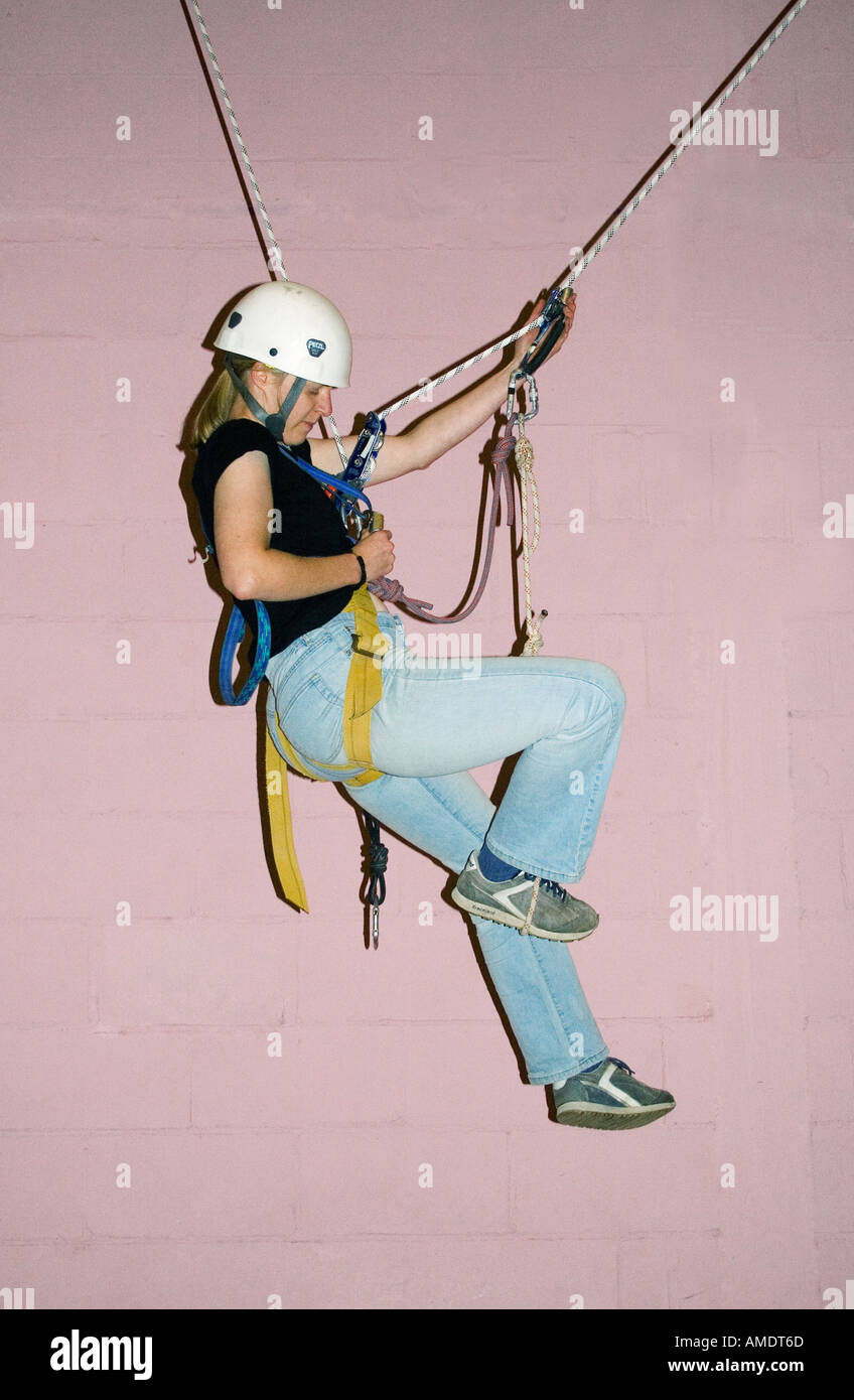 Female student traversing on a rope practising single rope technique ...