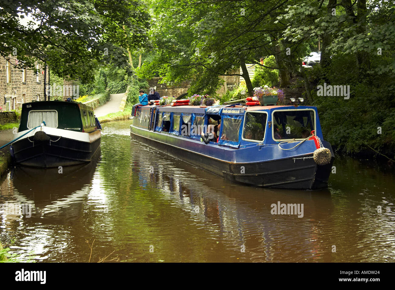 Excursion long boat on the canal at Uppermill West Yorkshire England
