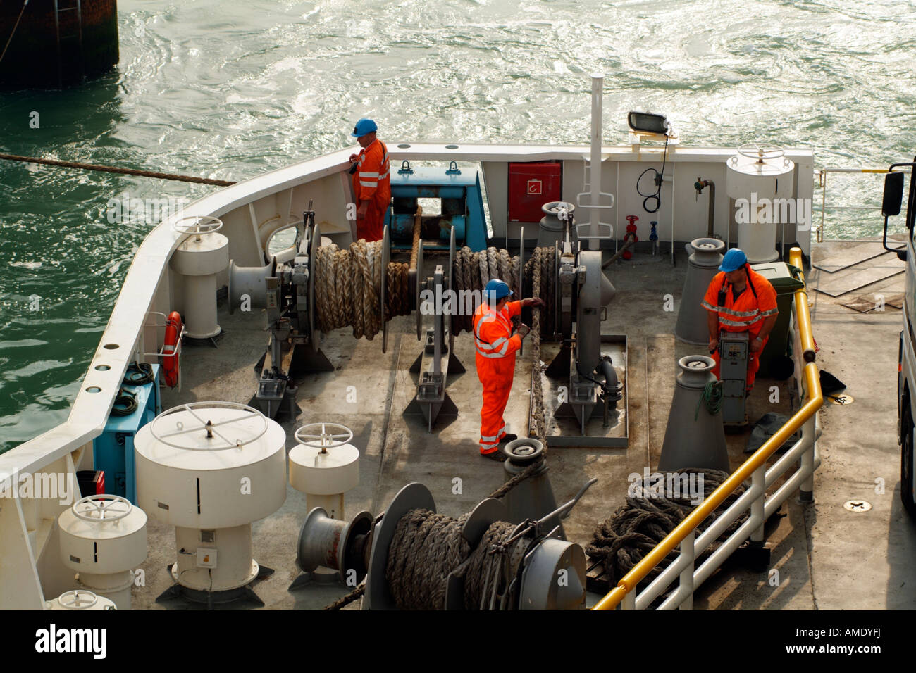 Ships Crew Winching Mooring Ropes on Stern of Cross Channel Ferry Stock
