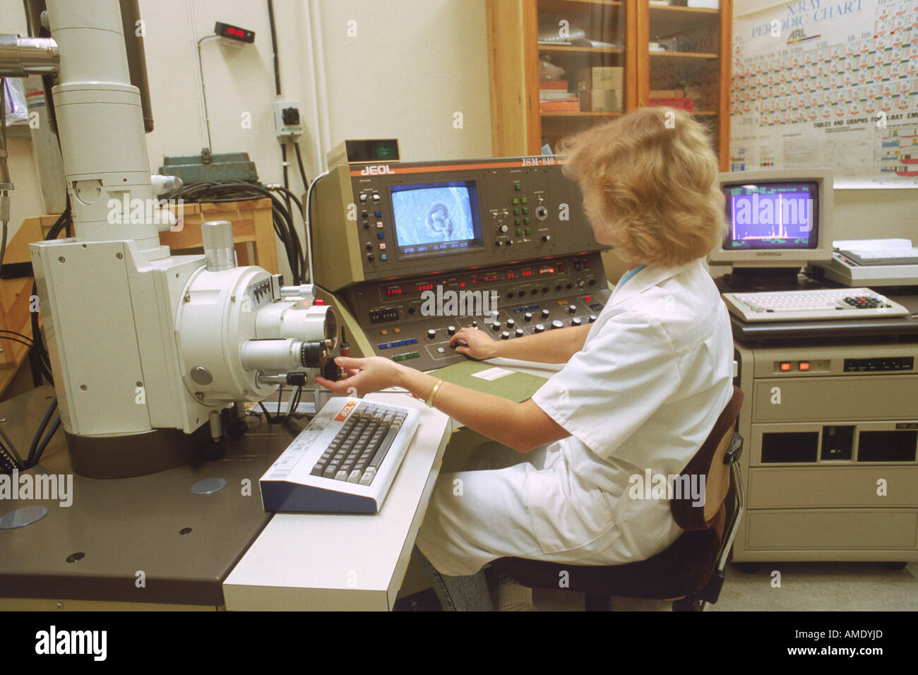 Woman in research lab with scanning electron microscope and x ray analyzer Stock Photo