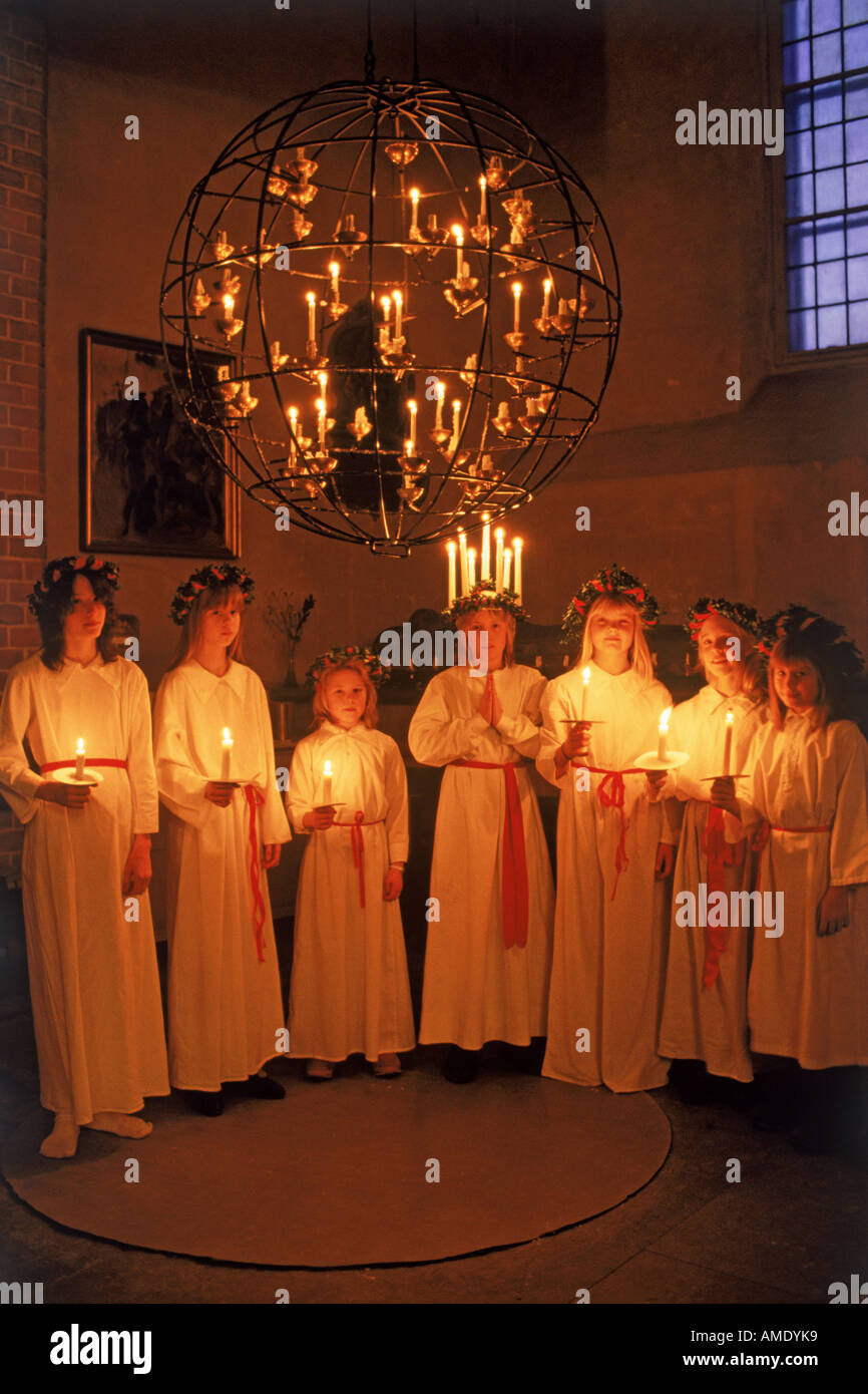 Girls with candles at Kungsholmen Church in Stockholm on Santa Lucia Day December 13 Stock Photo