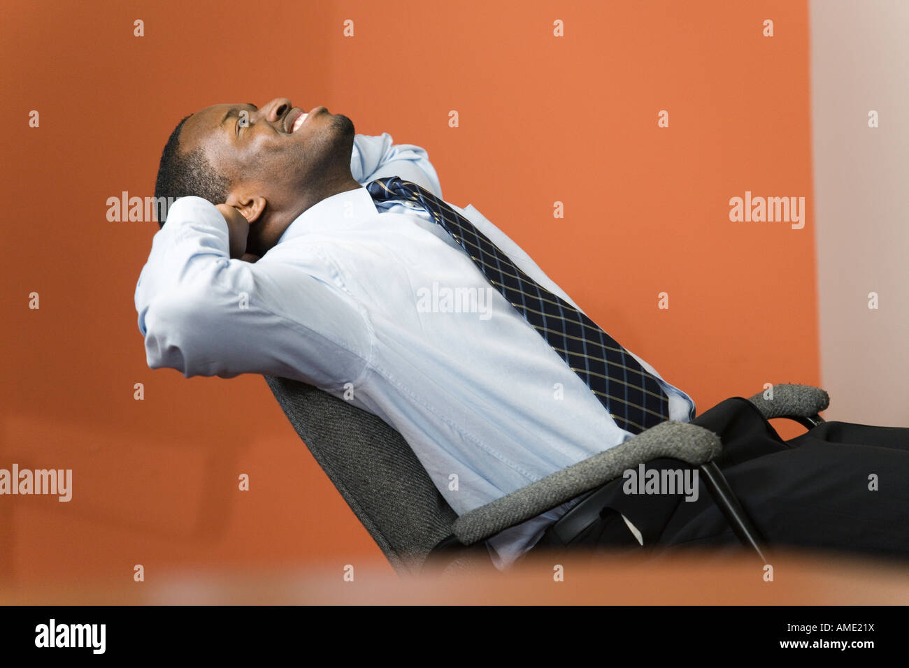 A Business man smiling in an office Stock Photo - Alamy