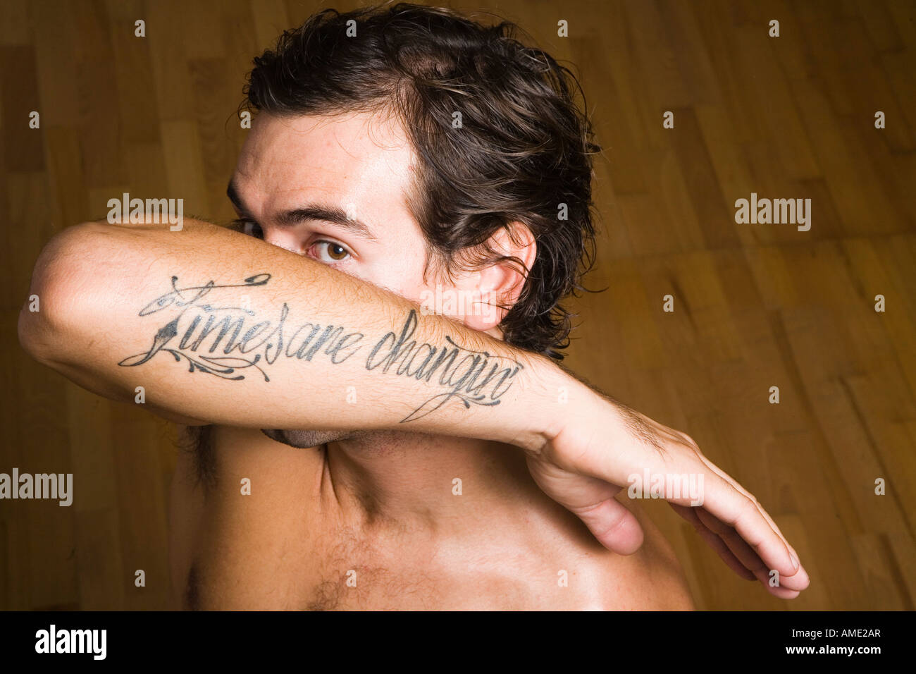 man covering face with arm Stock Photo - Alamy