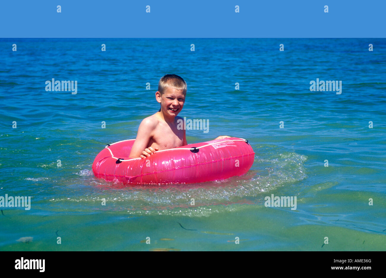 Young boy in floating tyre hi-res stock photography and images - Alamy