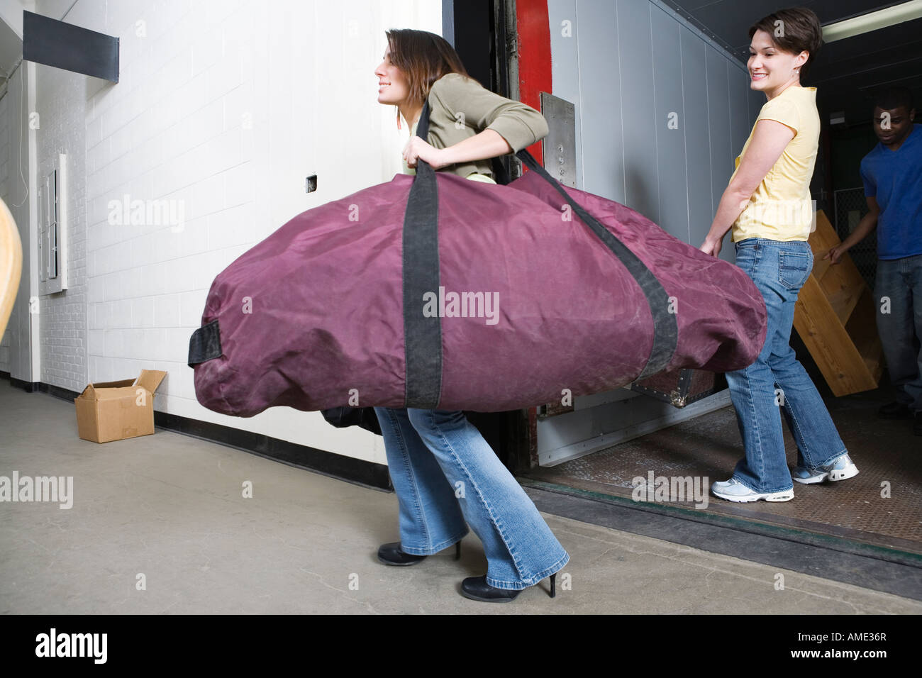 Young man carry heavy luggage hi-res stock photography and images - Alamy