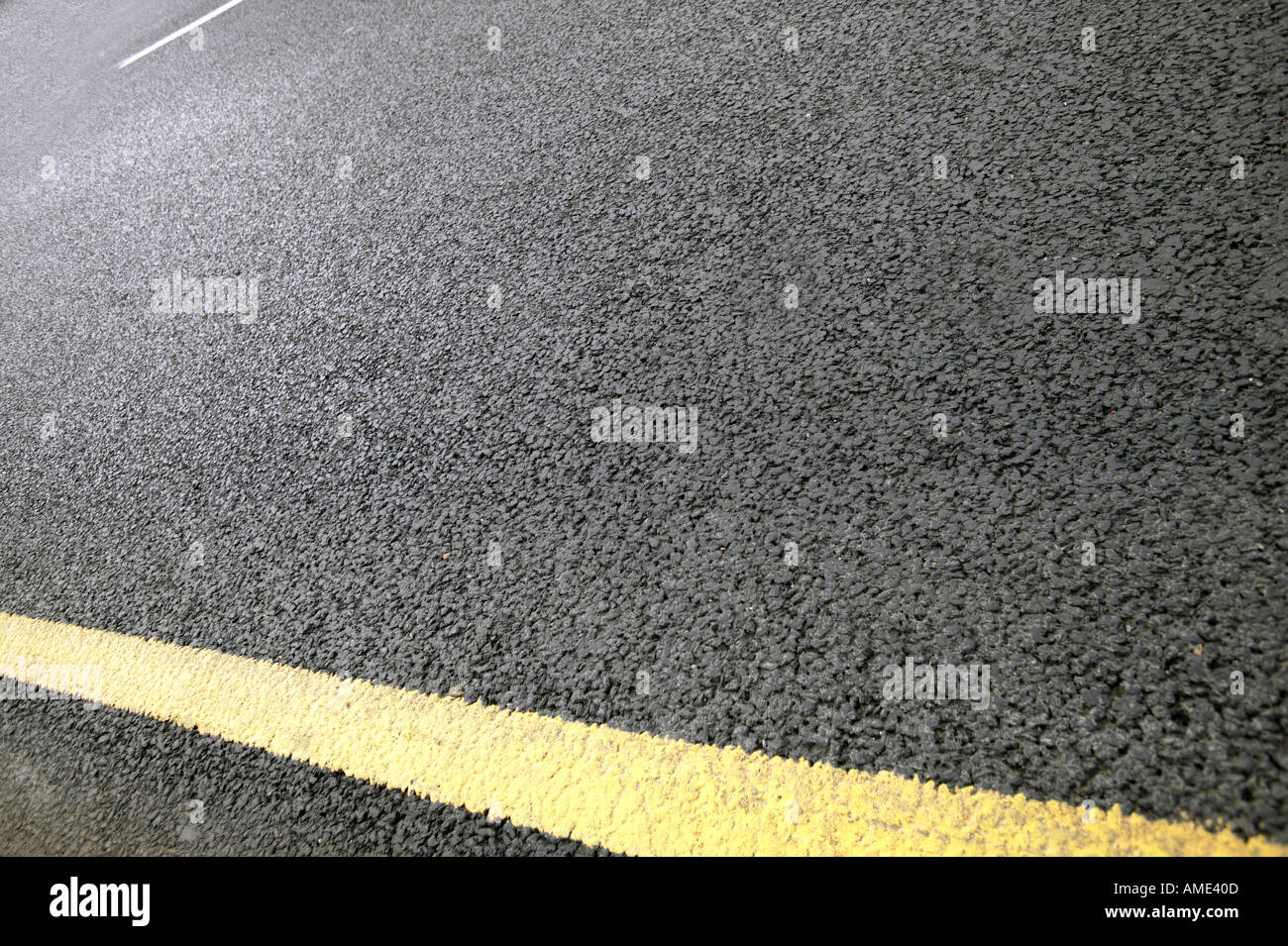 tarmac and a yellow line on a road Stock Photo