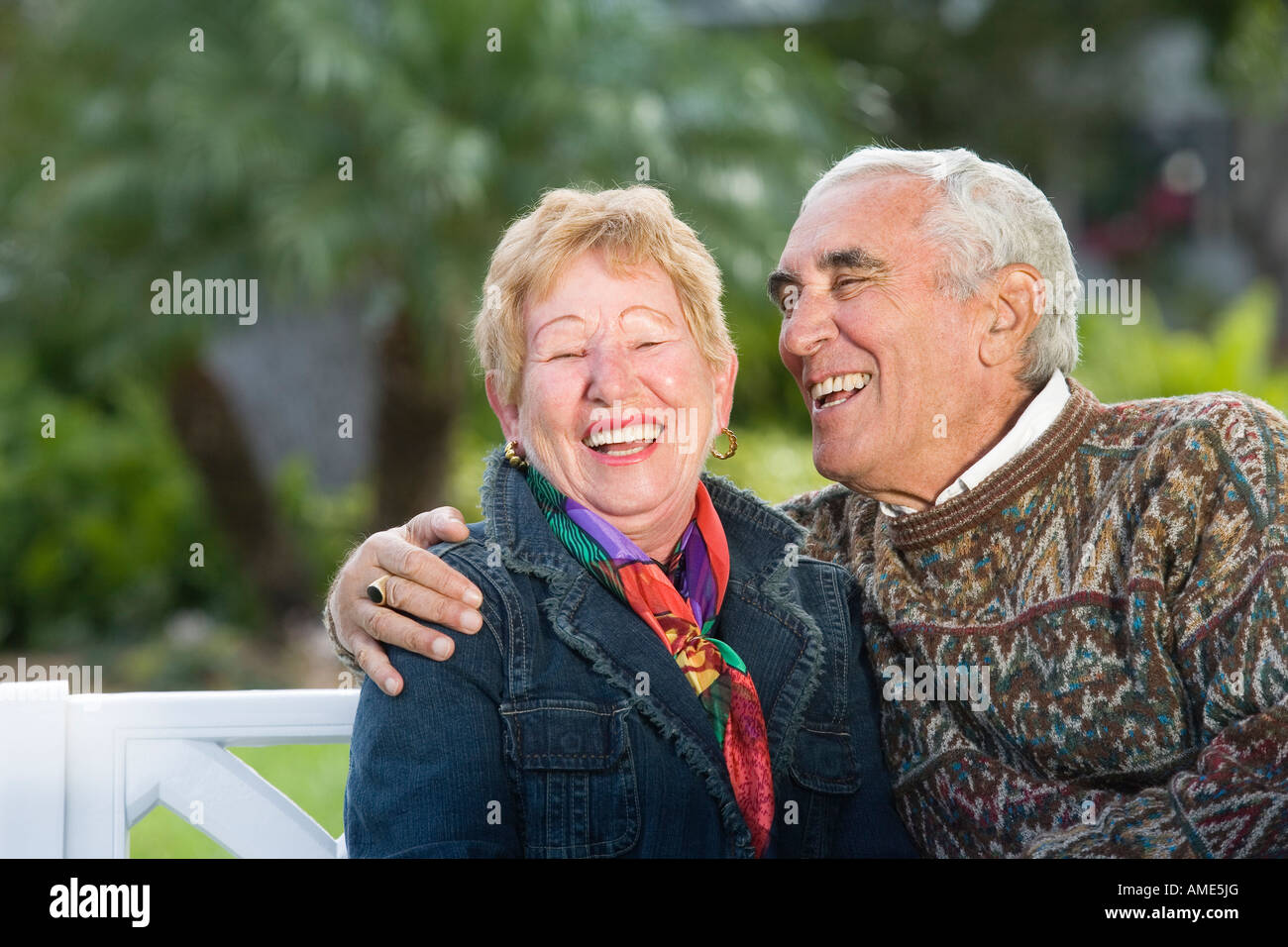 A senior couple sitting in a park Stock Photo - Alamy