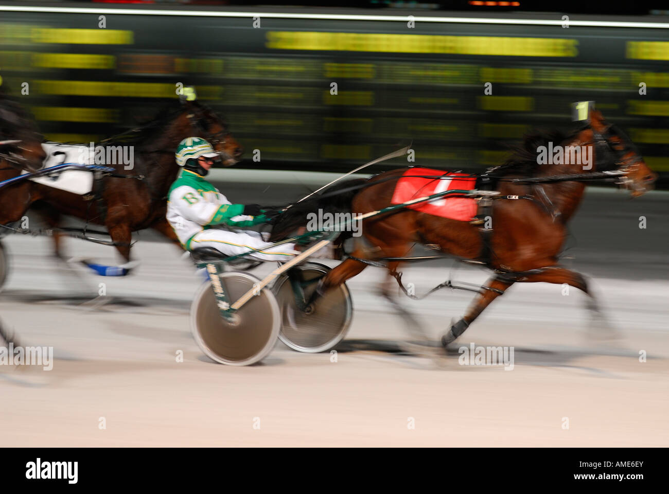 Number one harness racer breaks away at finish line to win at night in winter Ontario Stock Photo
