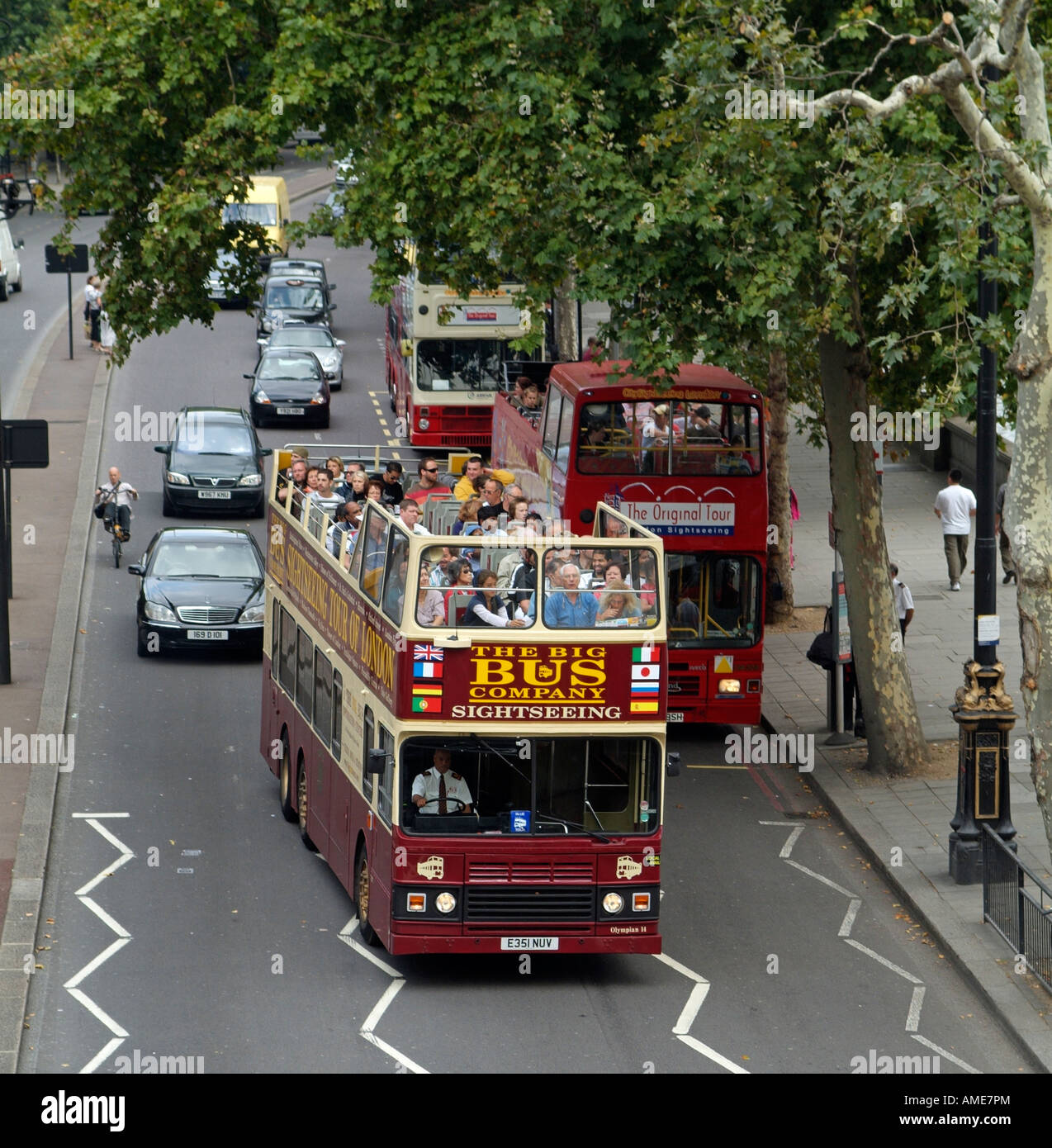 Sightseeing Double Decker Open Top Bus Touring London with Tourists Aboard Stock Photo