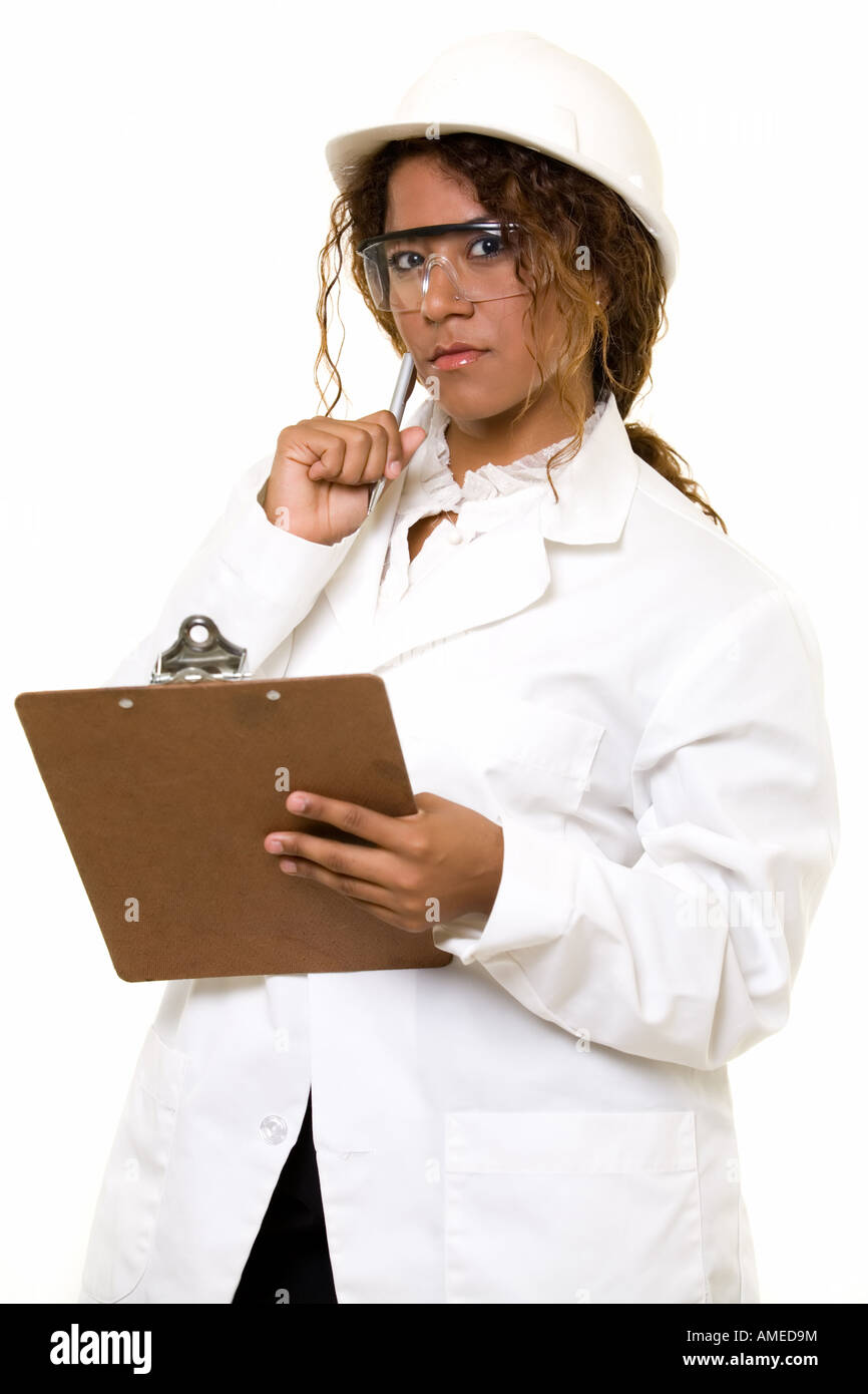 Attractive Hispanic woman in white lab coat and white safety hard hat ...