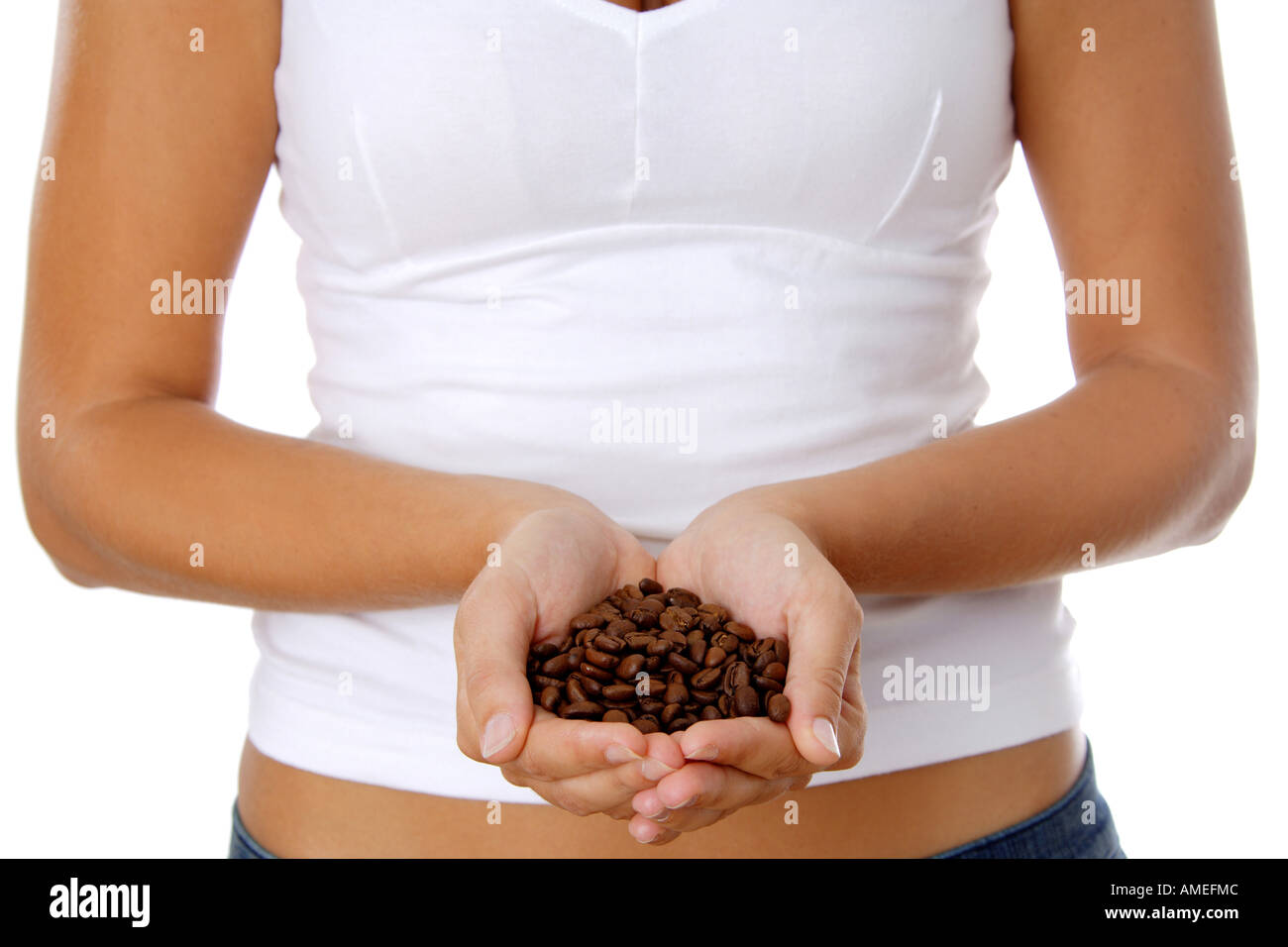 woman holding roasted coffee beans in her hands Stock Photo