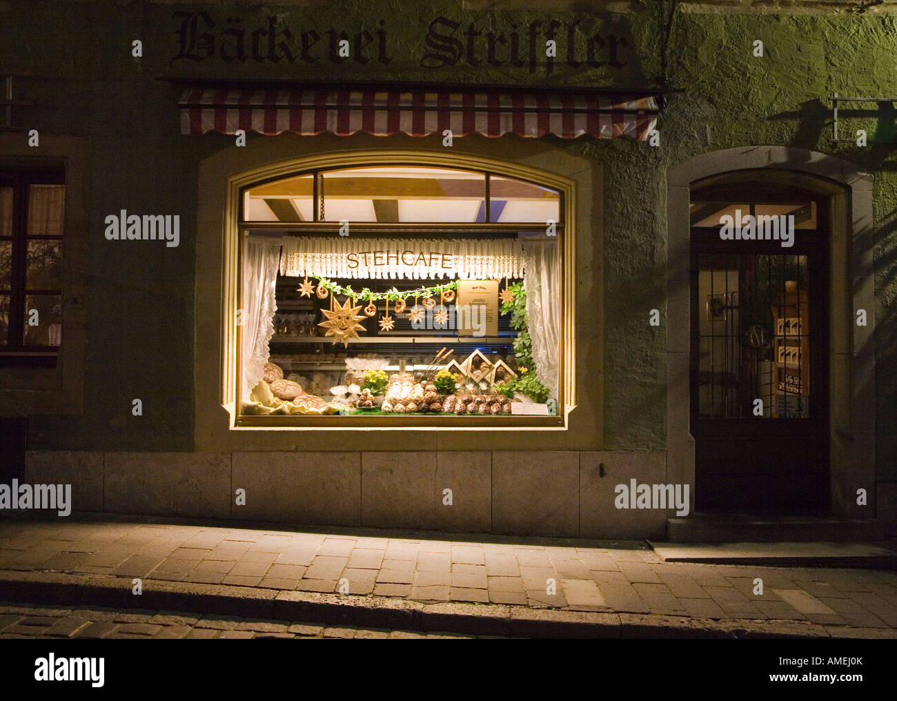 Cafe shop window display with speciality bread at night Rothenburg ob der Tauber Germany Stock Photo