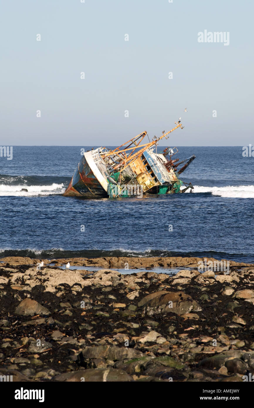 Banff registered Sovereign fishing trawler lies on rocks at Cairnbulg
