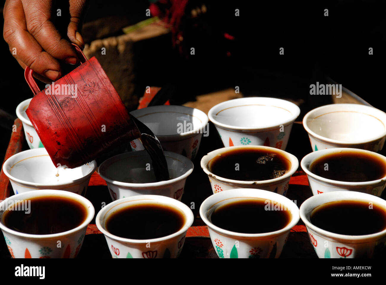 Pouring Ethiopian Coffee Into Porcelain Cups Pouring Ethiopian Coffee Into Porcelain Cups
