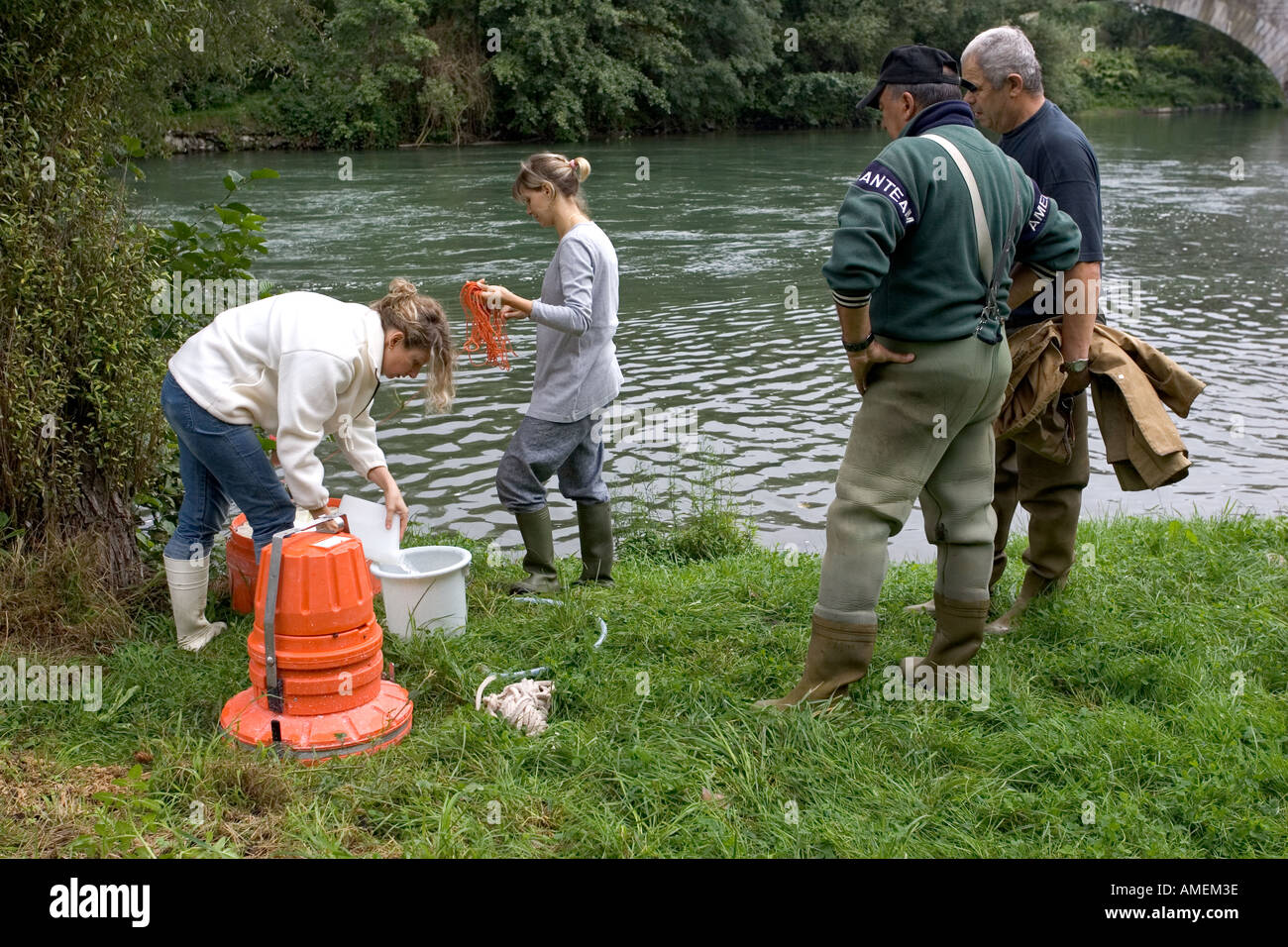 Environmental scientists checking water quality as part of brown trout management programme la Garonne river St Gaudiens France Stock Photo