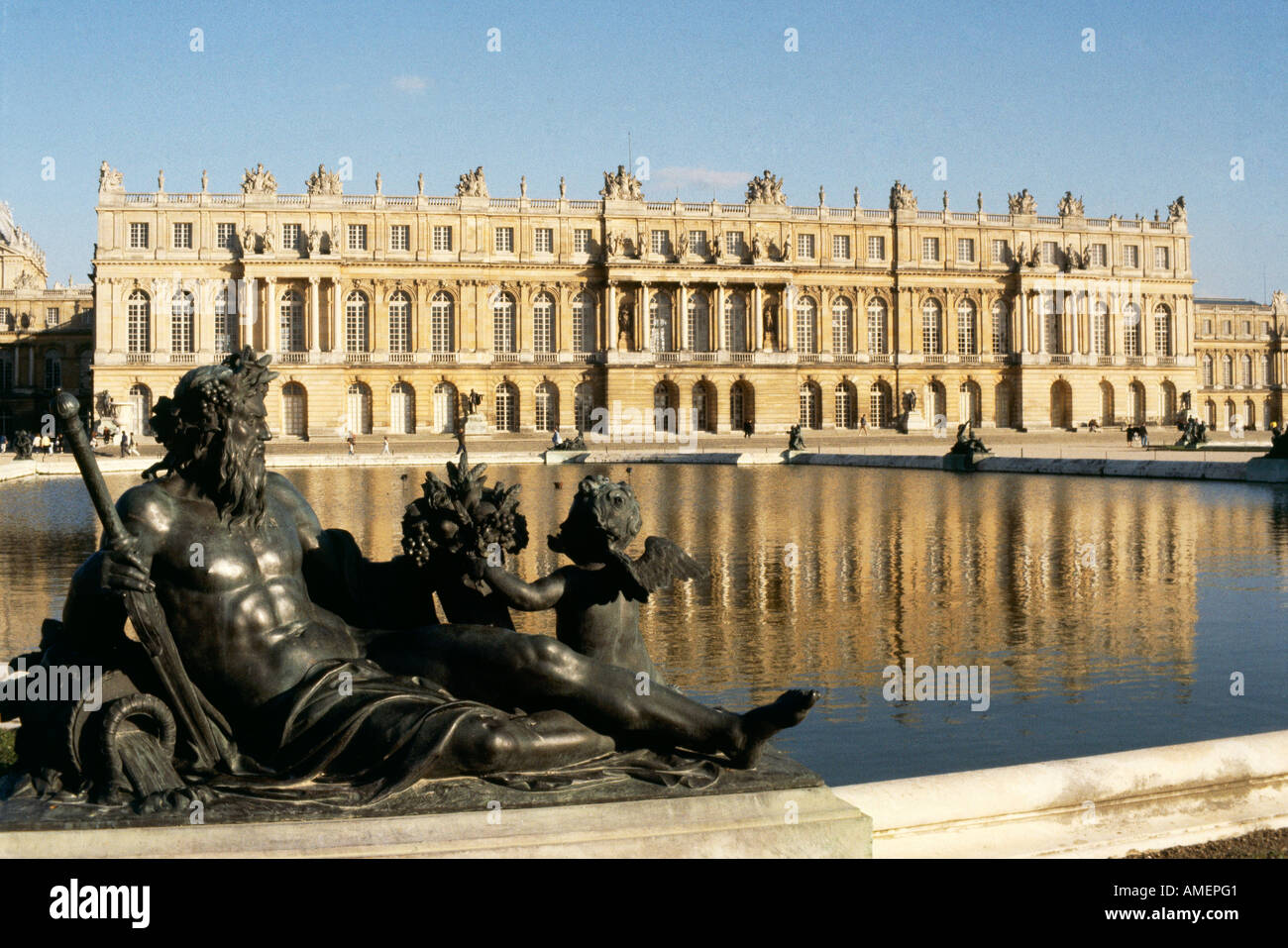 A view over the statues and ornamental water gardens towards the palace of Versailles Stock Photo