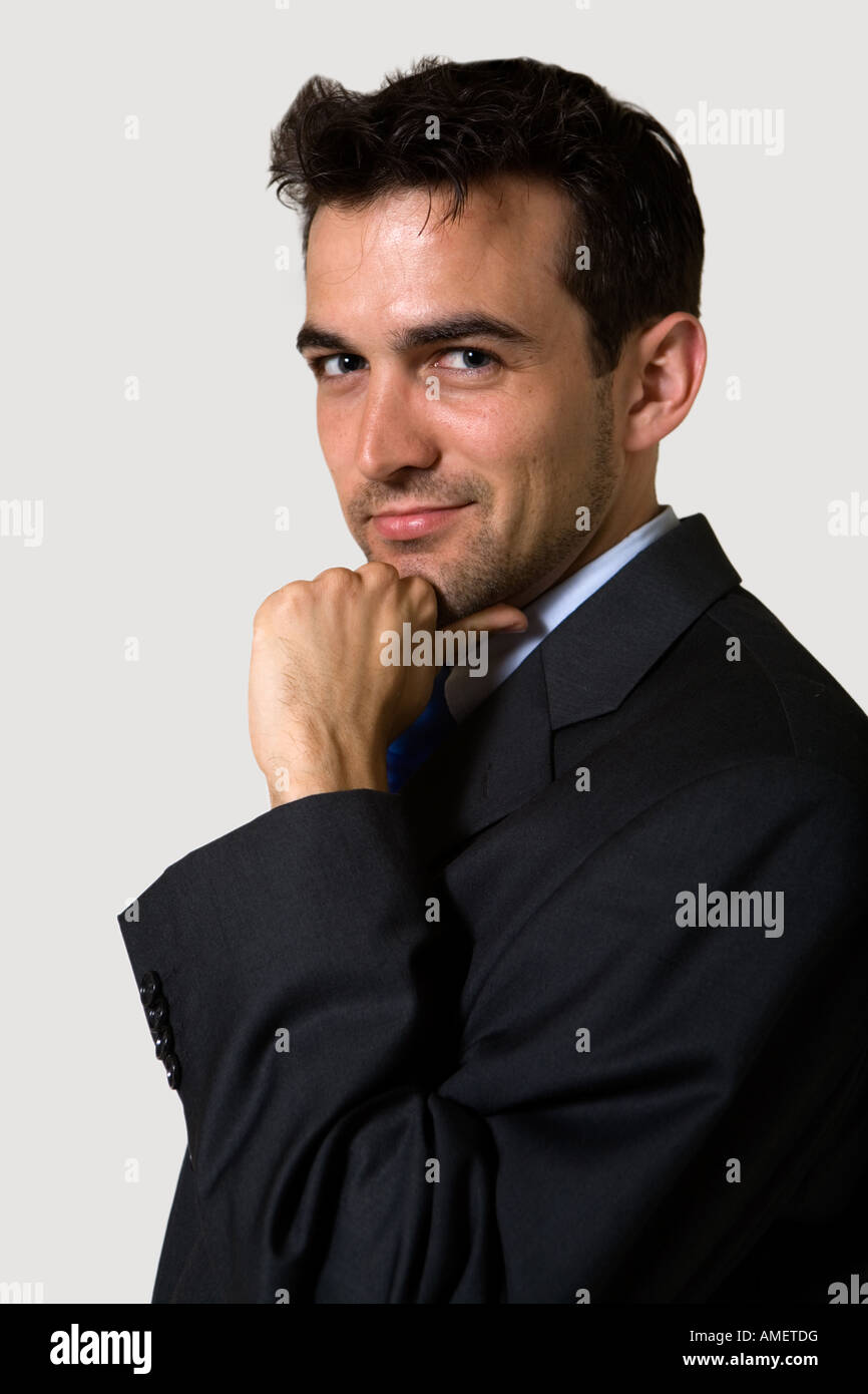 Handsome brunette young smiling business man wearing business suit with ...