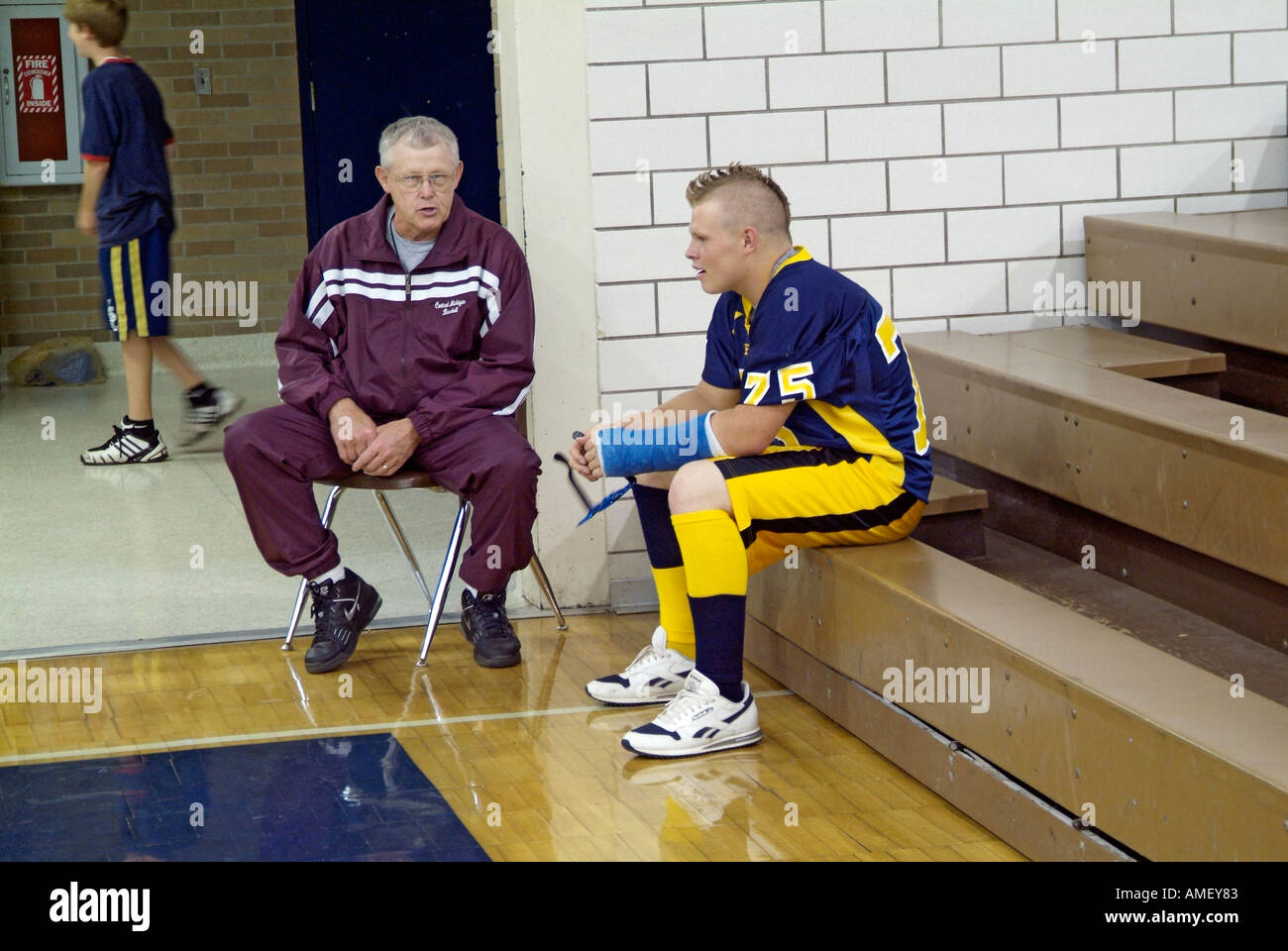 Coach talks with injured football player Stock Photo