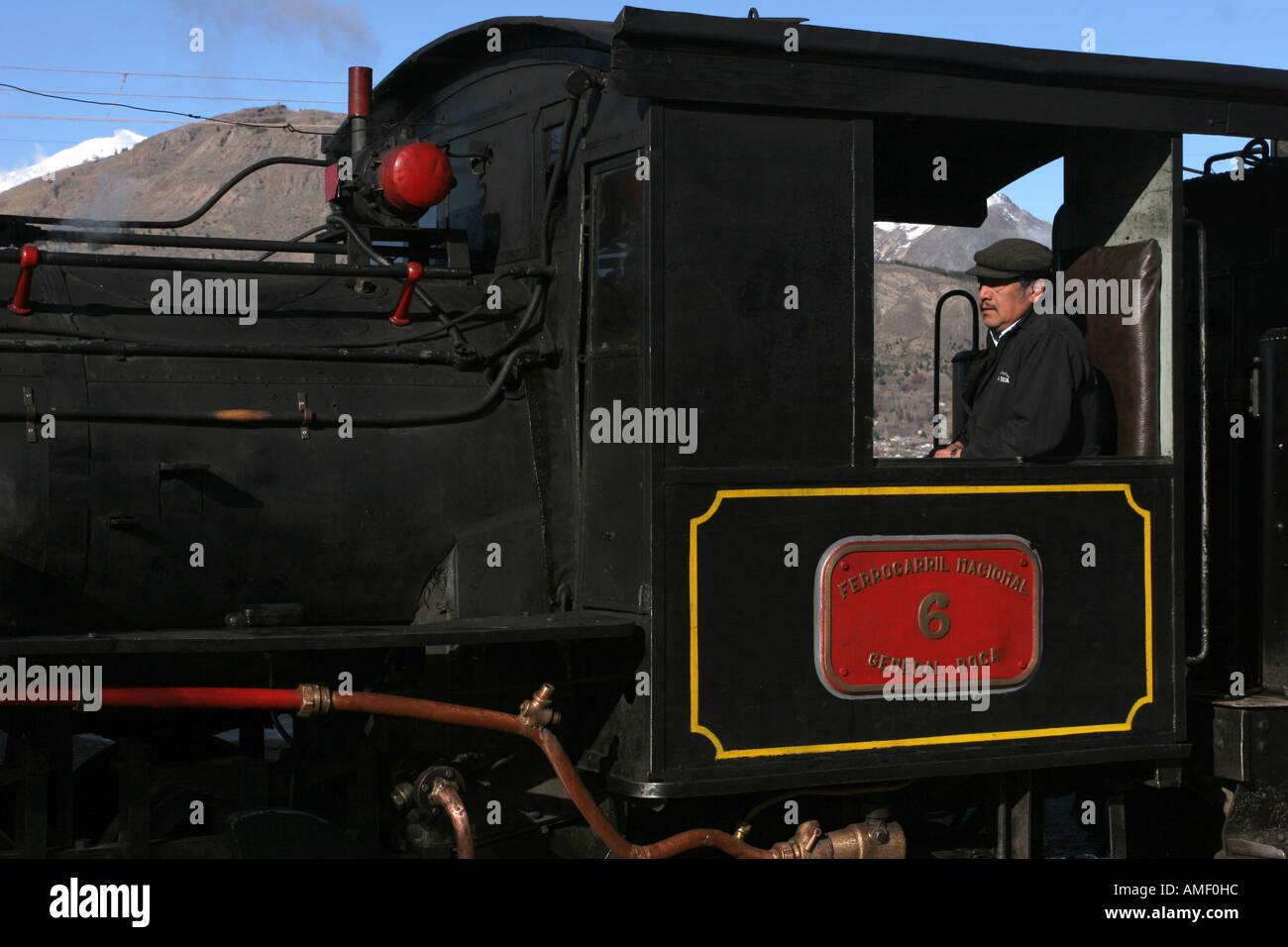 Old steam train locomotive driver of La Trochita about to leave the  Esquel, Chubut, Patagonia, Argentina, station. Stock Photo