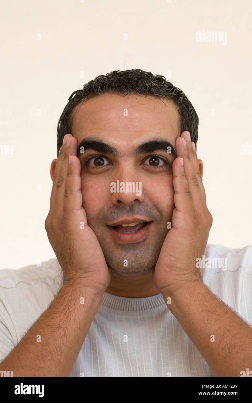surprised man hands on face Stock Photo