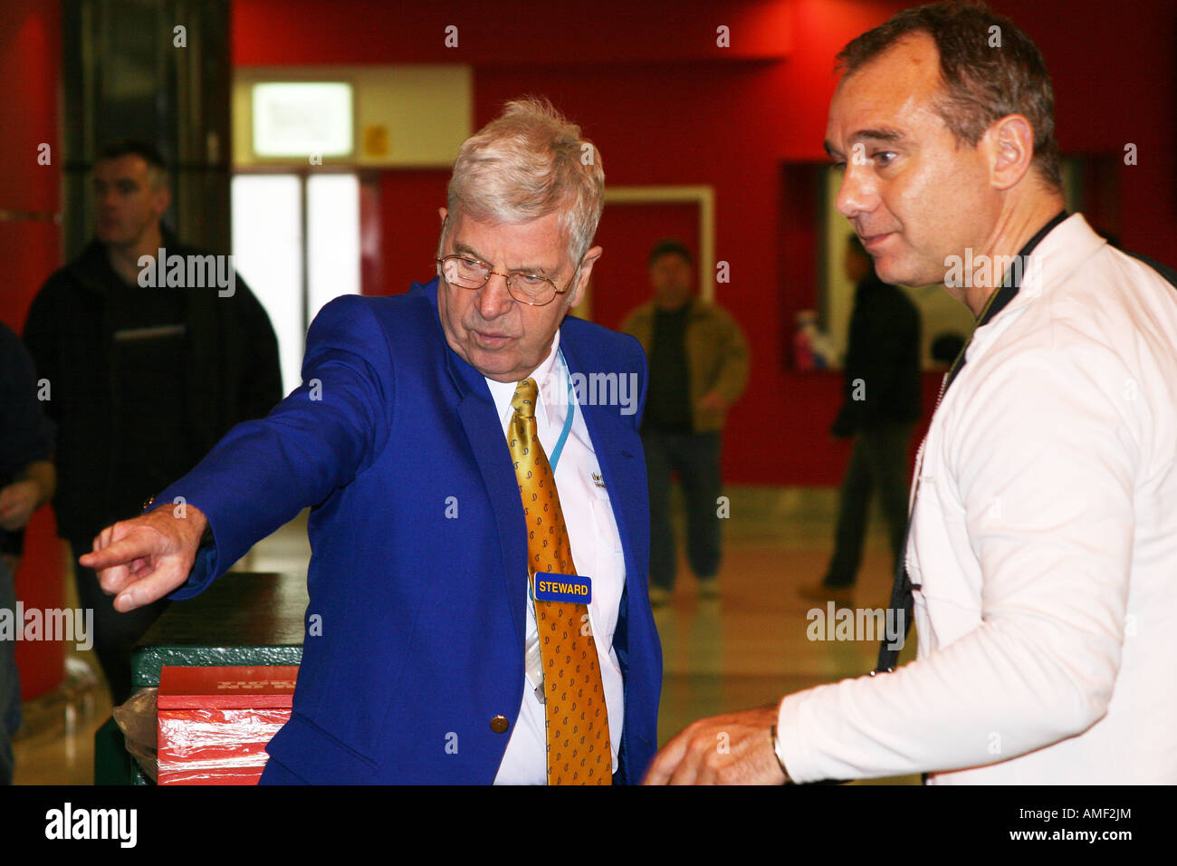 Steward in NEC show giving directions Stock Photo Alamy