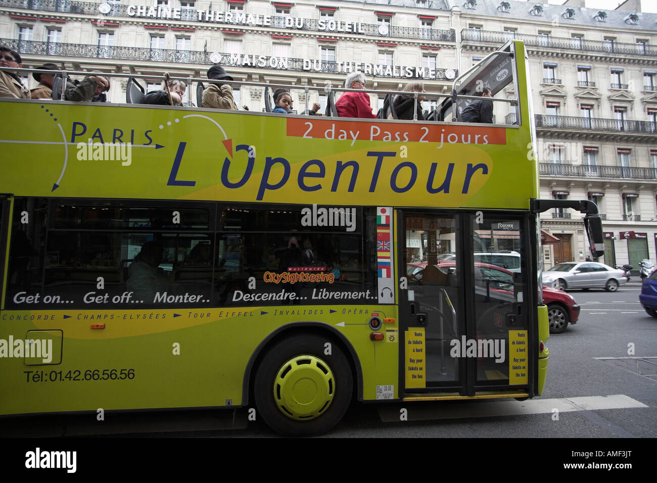 Open topped bus opposite 32, avenue de l'Opéra paris the maison de thermalisme L Open Tour Stock Photo