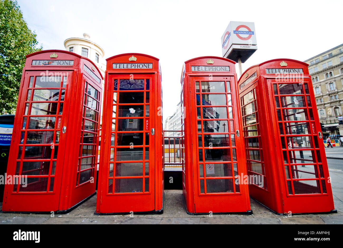 Four English red telephone booths and underground sign in London Stock Photo