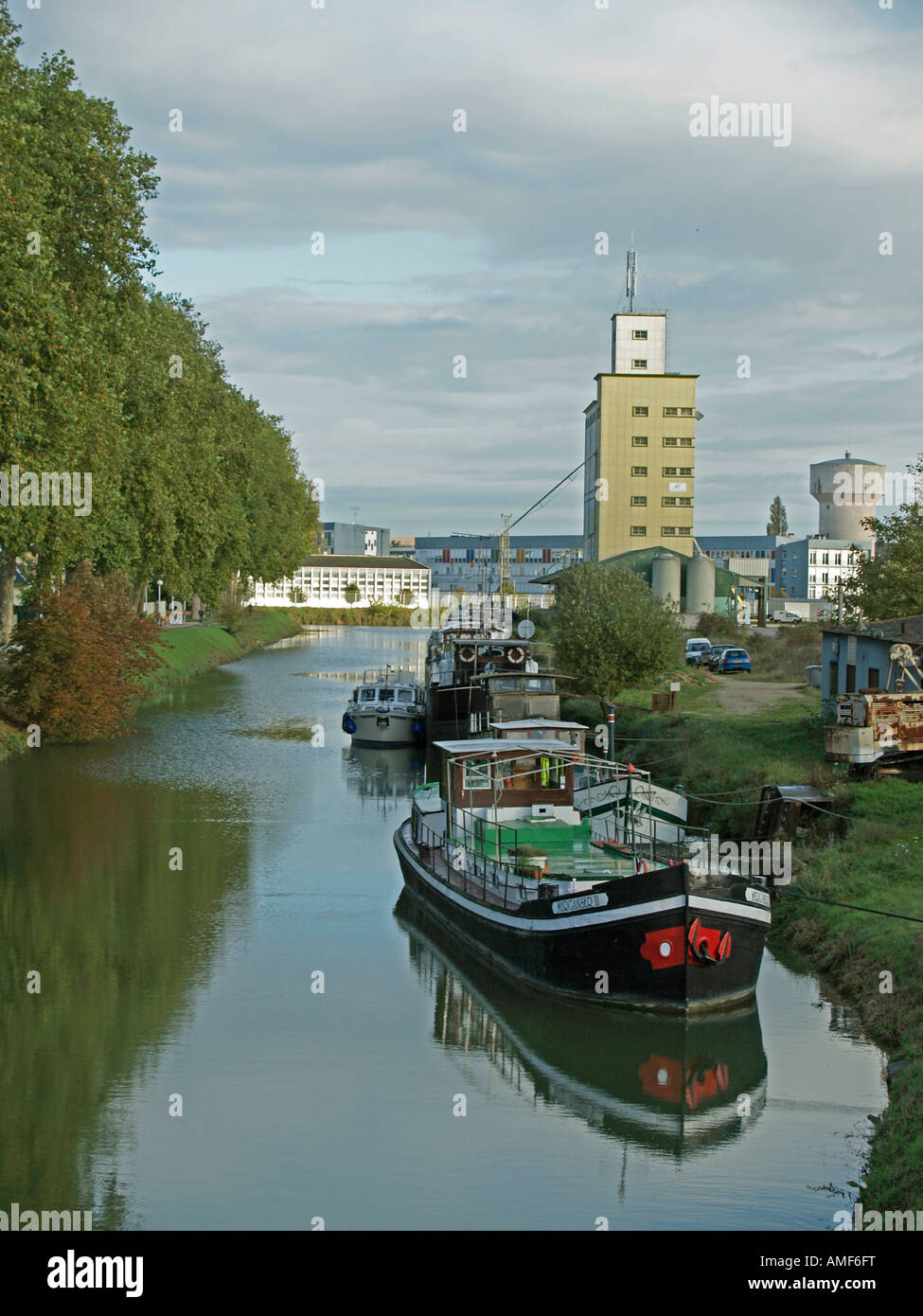 ships barges anchoring at a channel of a river at Canal de la Marne in Vitry le Francois Marne Champagne France Stock Photo