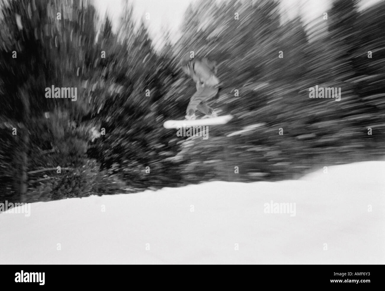 Snowboarder Jumping in Air Stock Photo