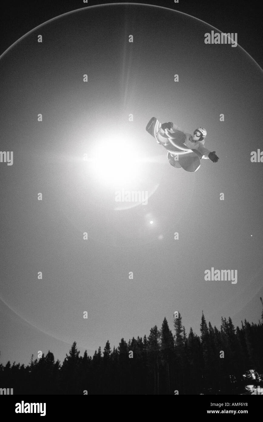 Snowboarder Jumping in Air Stock Photo