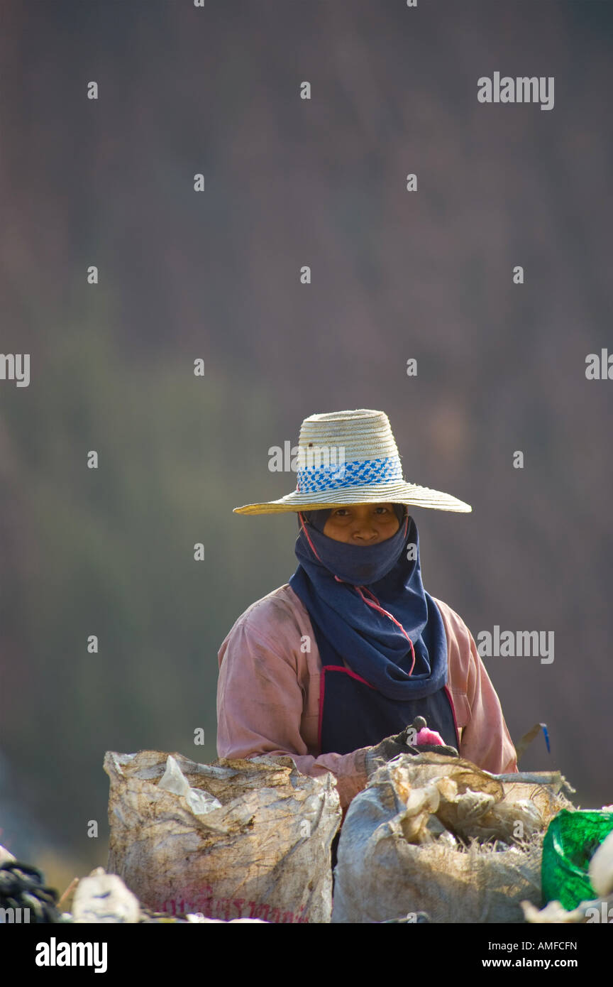The poor hand sorting waste for recycling at a landfill site in Thailand Stock Photo