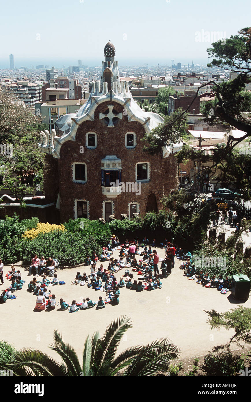 Party of schoolchildren on school trip in front of building, Guell Park, Barcelona, Spain Stock Photo