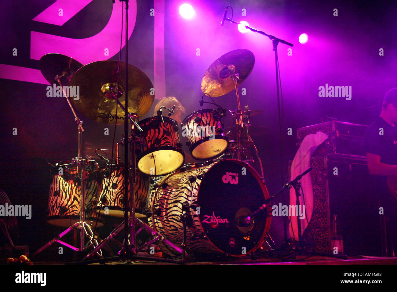 drummer performing on stage under purple stage lighting Stock Photo Alamy