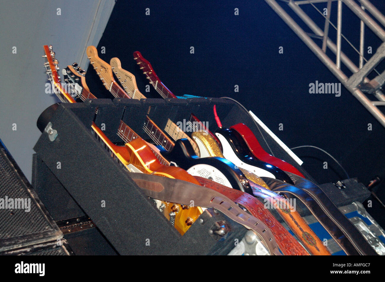 collection of electric guitars in rack on stage Stock Photo Alamy