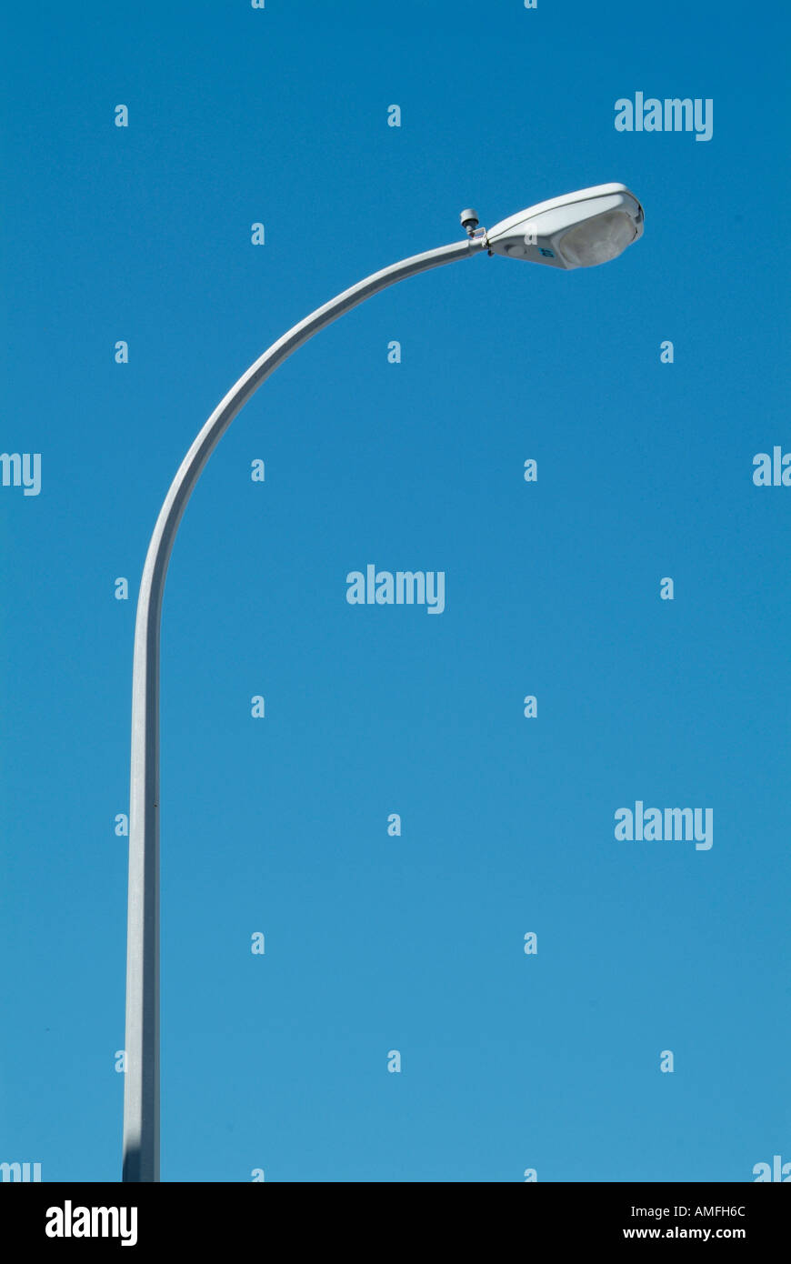 Street Light with surveillance camera mounted to guard a shopping mall parking lot Stock Photo