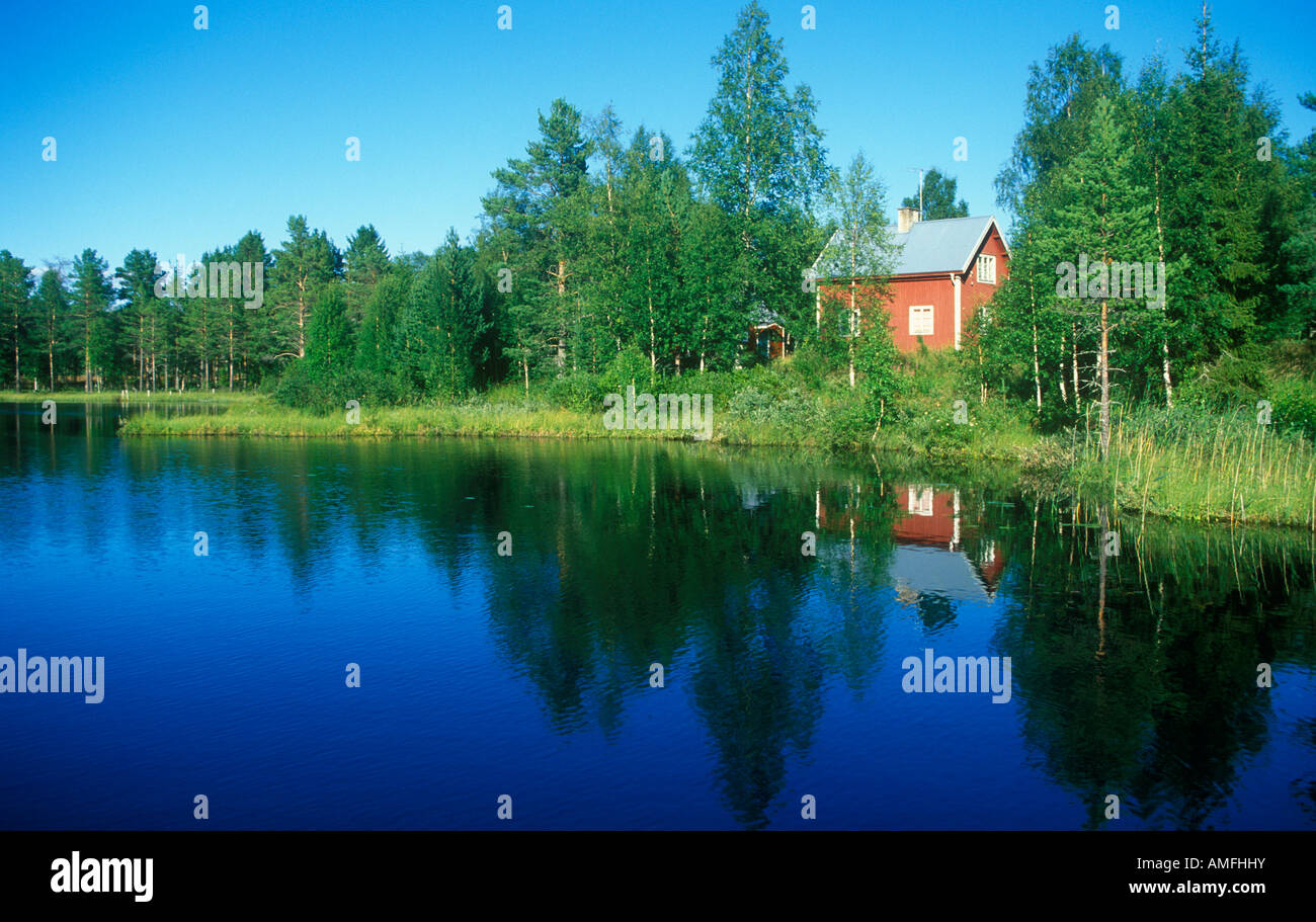 typical red wooden house at a lake in Central Sweden Stock Photo - Alamy