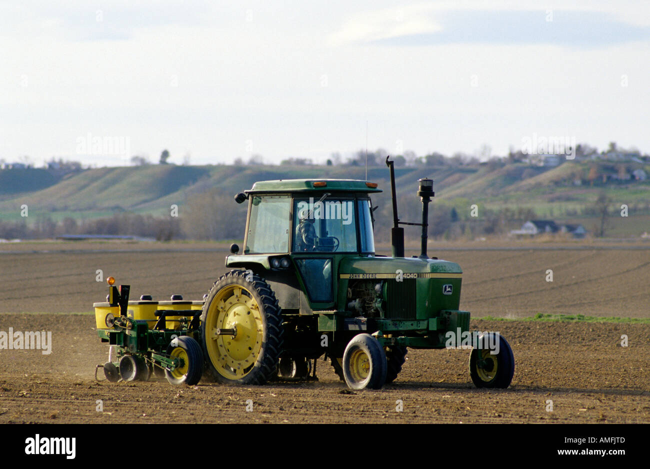 A tractor planting corn seed near Nampa, Idaho. Stock Photo