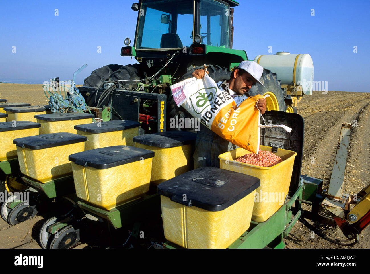 A farmer filling planter with corn seed. Stock Photo