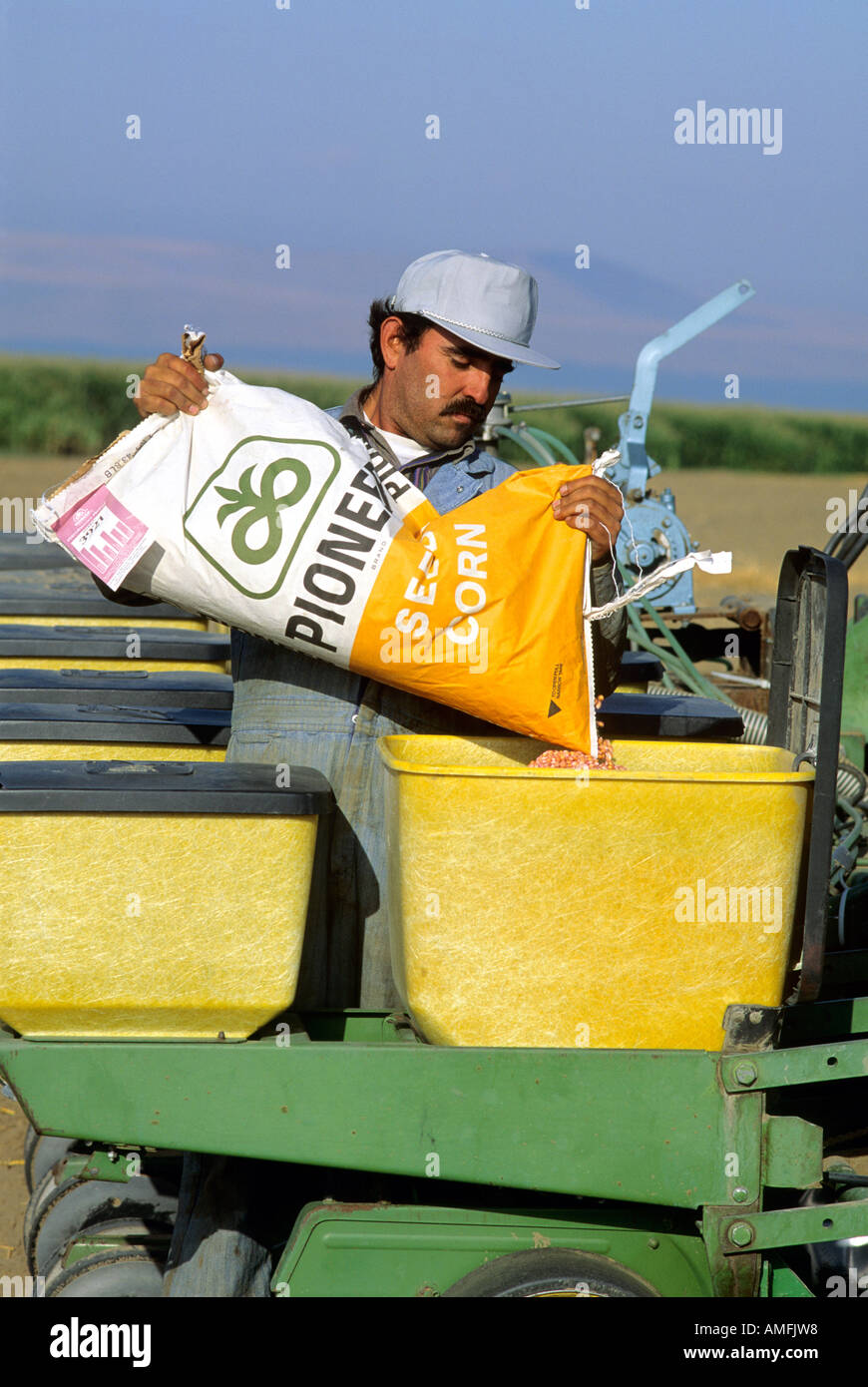A farmer filling planter with corn seed. Stock Photo